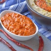 Harissa Sauce or Harissa Paste is spicy chile sauce blended with spices. Add to marinades, hummus, salad dressings and more for some heat! #harissa #hotsauce www.savoryexperiments.com