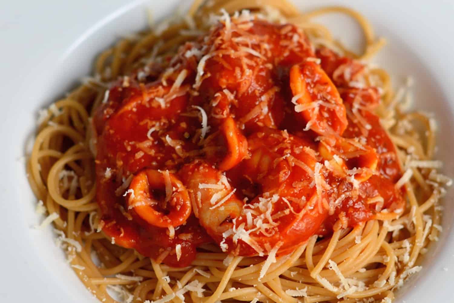 This Seafood Fra Diavolo Recipe is one of my favorite seafood pasta recipes ever! Fra Diavolo is a deliciously spicy marinara with fresh seafood! #fradiavolorecipe #shrimpfradiavolo www.savoryexperiments.com 