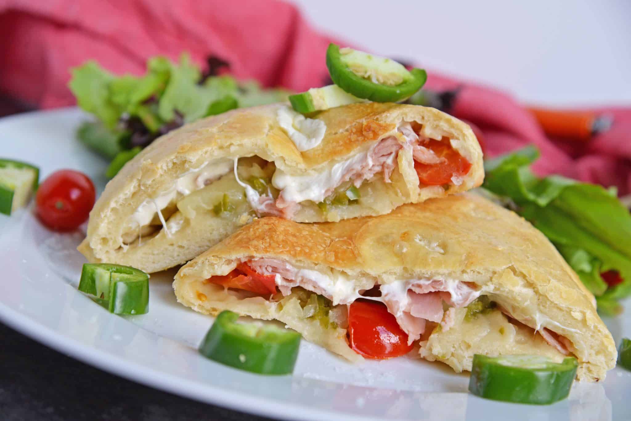 Spicy Hawaiian Calzones have become a favorite lately in this household! This is a easy calzone recipe just like your favorite Hawaiian Pizza with ham, pineapple and jalapenos! #hawaiianpizza #hawaiianfood www.savoryexperiments.com