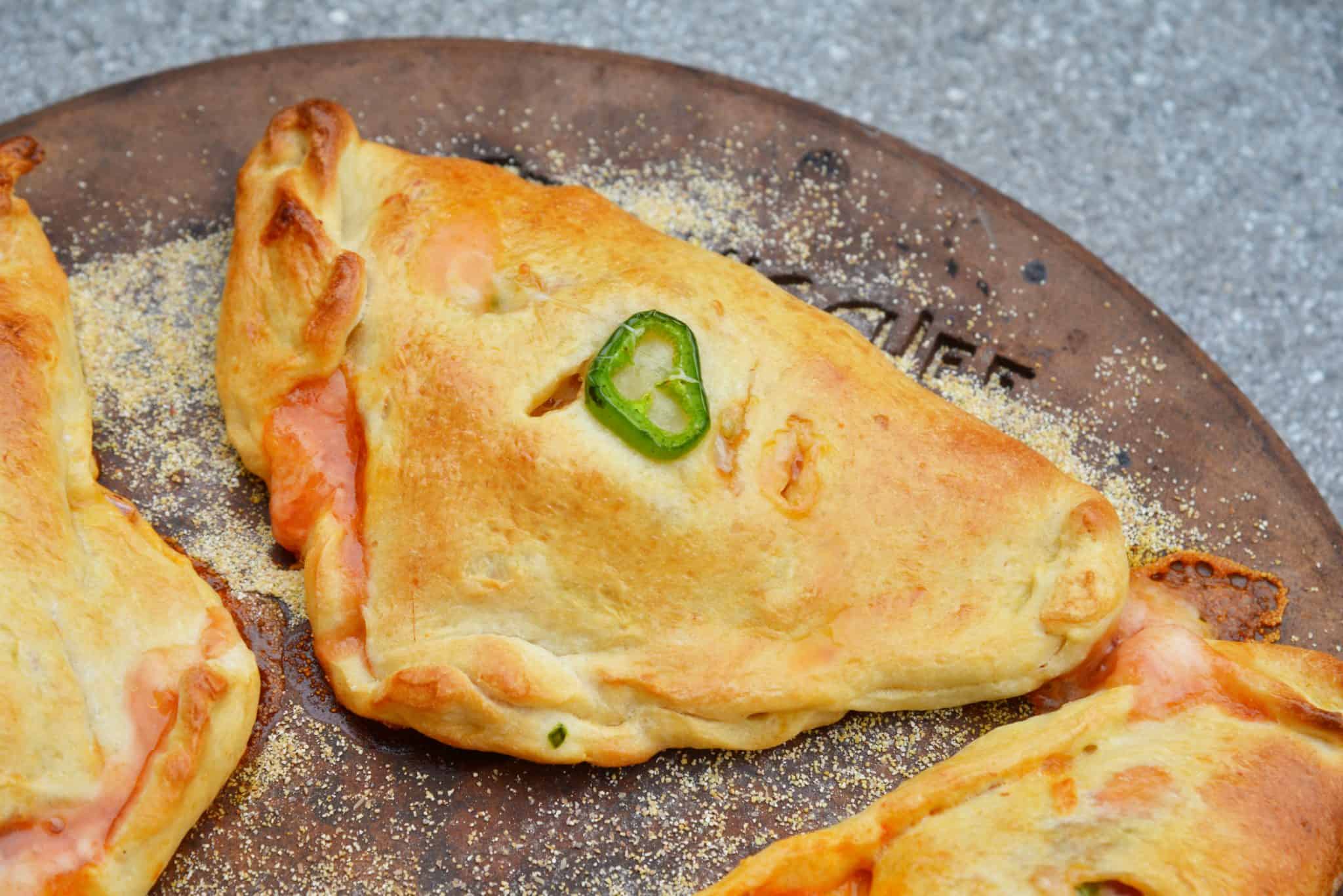 Spicy Hawaiian Calzones have become a favorite lately in this household! This is a easy calzone recipe just like your favorite Hawaiian Pizza with ham, pineapple and jalapenos! #hawaiianpizza #hawaiianfood www.savoryexperiments.com