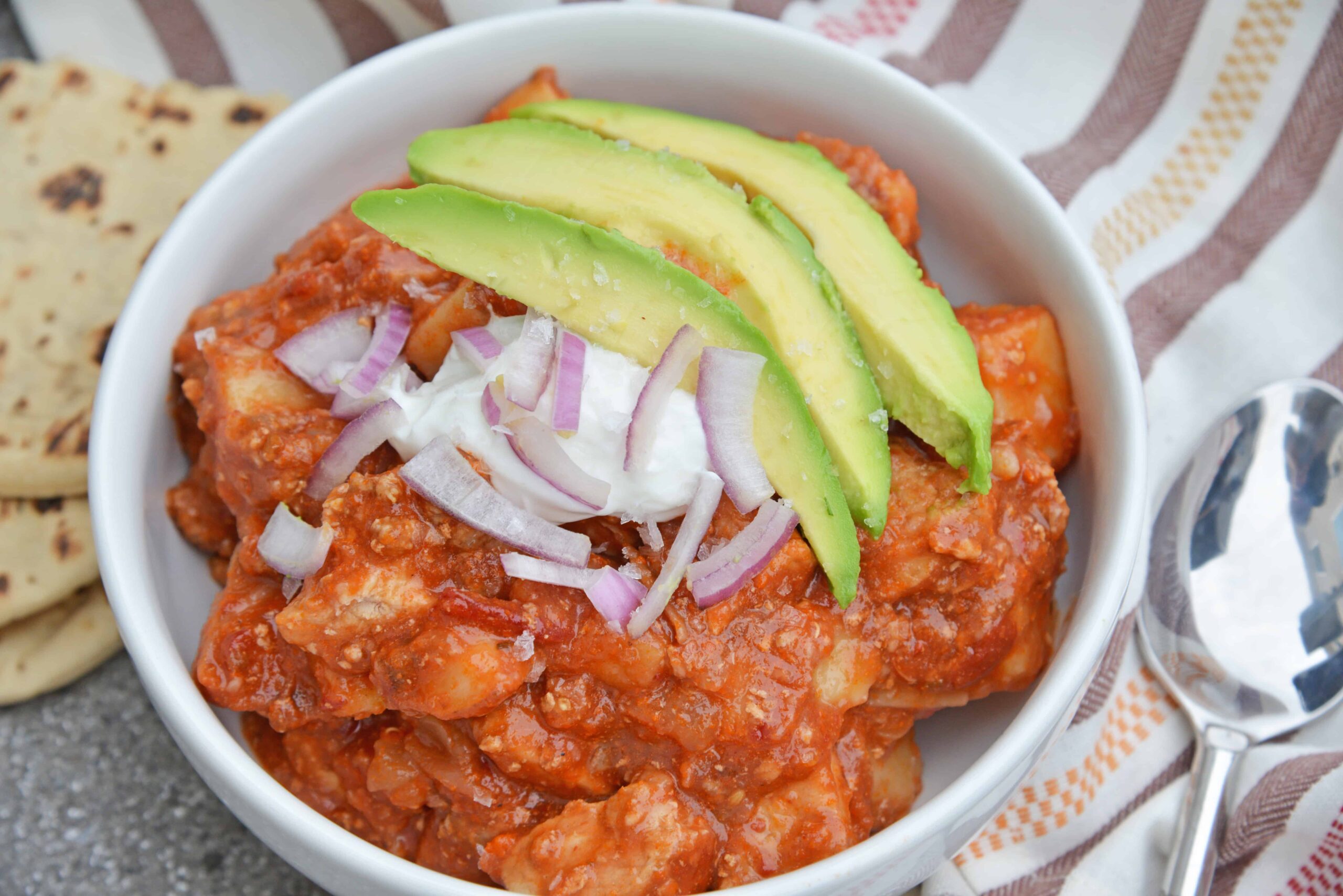 Spicy Pork and Potato Stew uses tender pork cuts and potato simmered in Middle Eastern spices and tomato sauce. Chipotle chiles in adobo sauce and chorizo bring loads of flavor. #porkstew #onepotmeals www.savoryexperiments.com