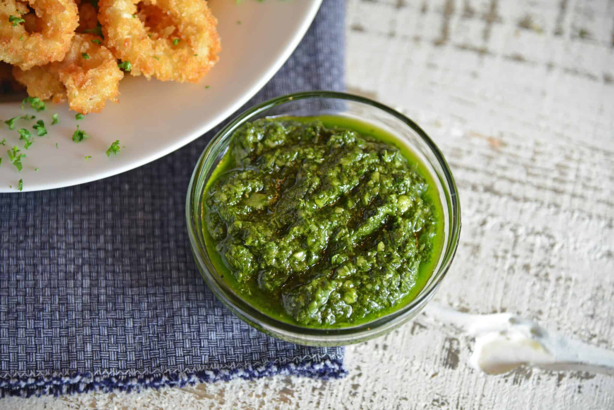 Chimichurri Fried Calamari is a quick and delicious appetizer recipe that can please any crowd! Served with fresh chimichurri sauce, it is a delicious twist. #friedcalamari #easycalamarirecipe www.savoryexperiments.com