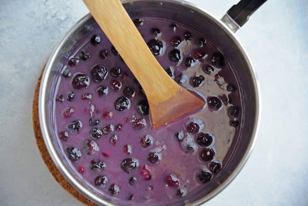 Homemade Blueberry Syrup is the perfect quick blueberry pancake syrup for pancakes and waffles. Uses a blueberry compote and comes together in 30 minutes! #blueberrysyrup #blueberrypancakesyrup www.savoryexperiments.com