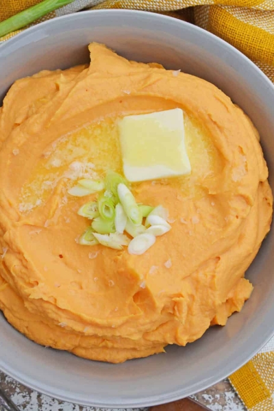 This Mashed Sweet Potatoes recipe uses baked sweet potatoes with natural sugars, bay leaf infused cream and a spike of orange juice for the best sweet potato mash ever! #sweetpotatomash #mashedsweetpotatoes www.savoryexperiments.com