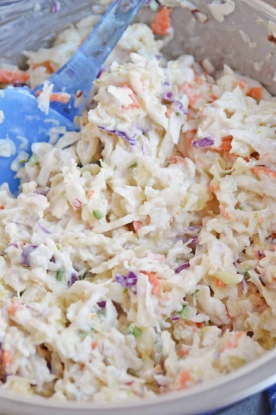 Yogurt Pineapple Coleslaw is a delicious homemade coleslaw that you can have ready in just 10 minutes! It has a yummy sweet and spicy flavor profile to it! #pineapplecoleslaw #nomayocoleslaw #healthycoleslawrecipe www.savoryexperiments.com