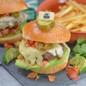 Taco Burgers are a spicy mix of tacos and burgers! Topped with pico de gallo, avocado slices, jalapenos, pepper jack cheese and cool sour cream.