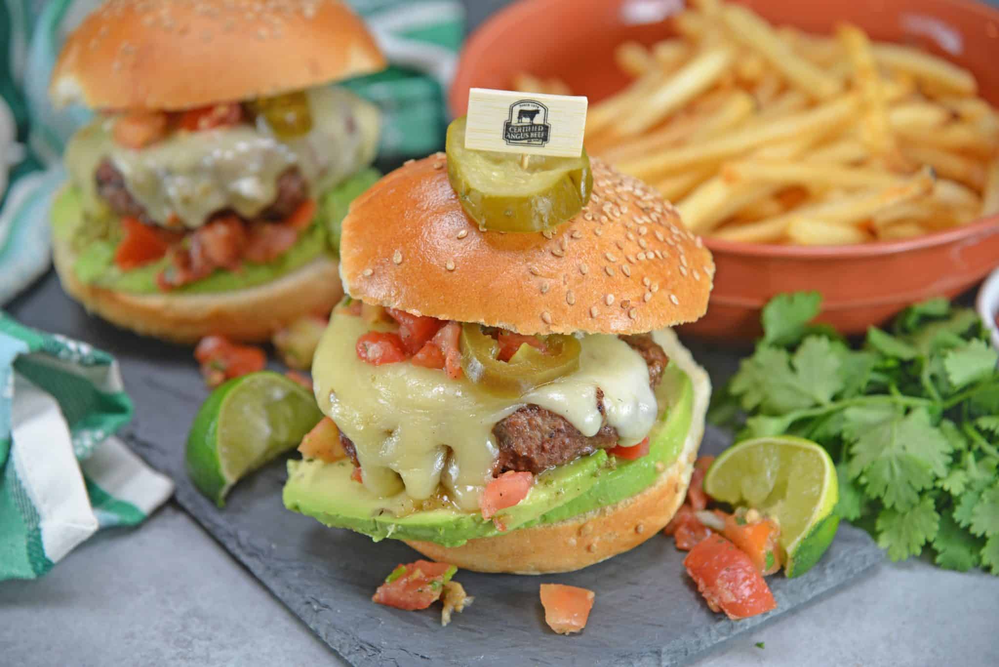 Taco Burgers are a spicy mix of tacos and burgers! Topped with pico de gallo, avocado slices, jalapenos, pepper jack cheese and cool sour cream.