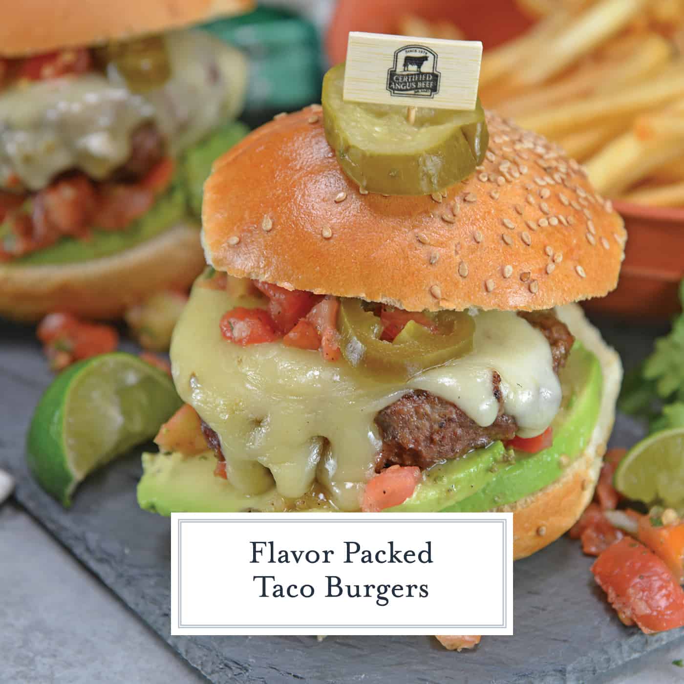 Taco Burgers are a spicy mix of tacos and burgers! Topped with pico de gallo, avocado slices, jalapenos, pepper jack cheese and cool sour cream. #gourmethamburgers #tacohamburger www.savoryexperiments.com
