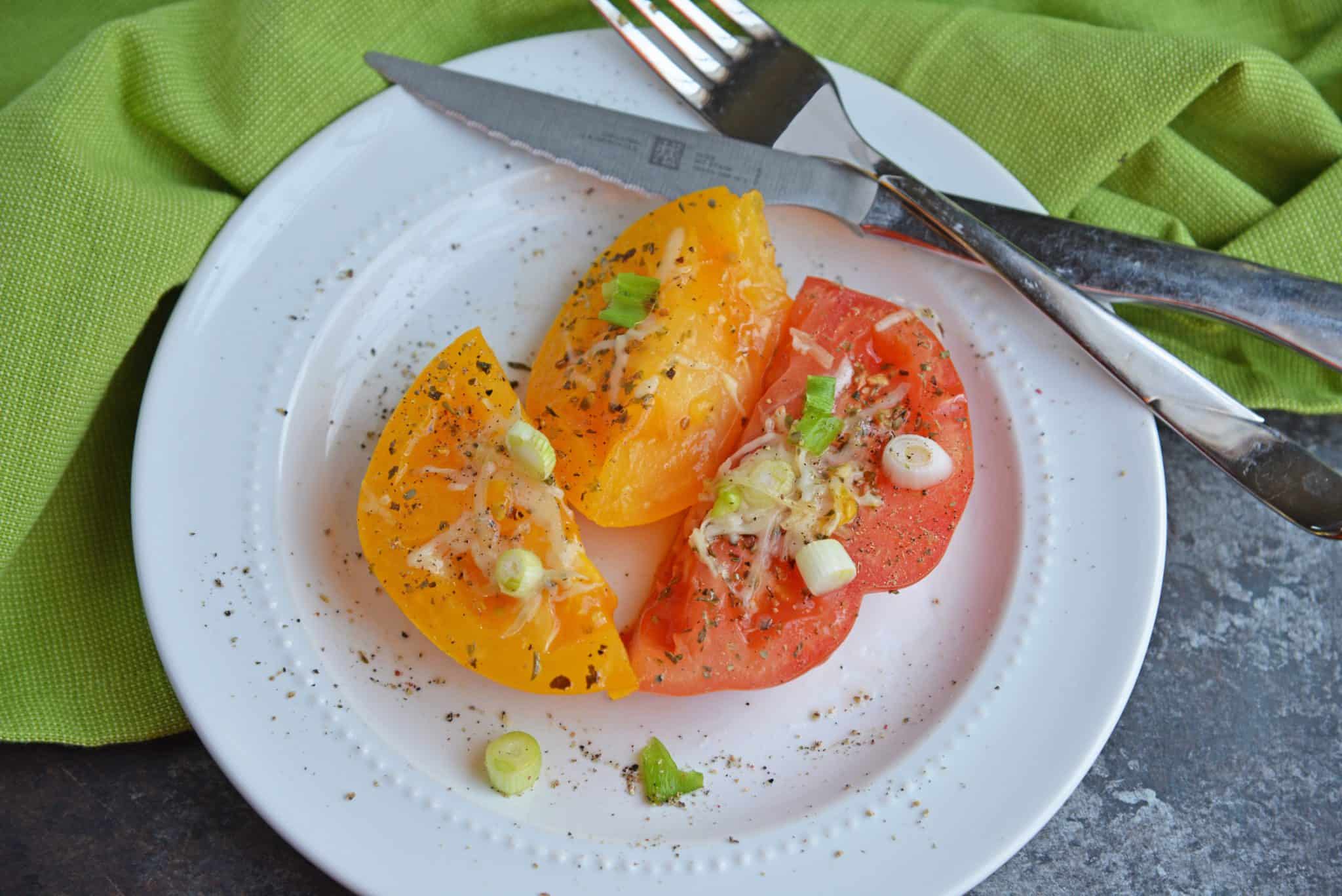 Parmesan Tomatoes are whole tomatoes, cut in half and baked with Parmesan cheese, Italian seasoning and garnished with lush scallions. An easy side dish recipe for any meal!  #tomatosidedishrecipes www.savoryexperiments.com 