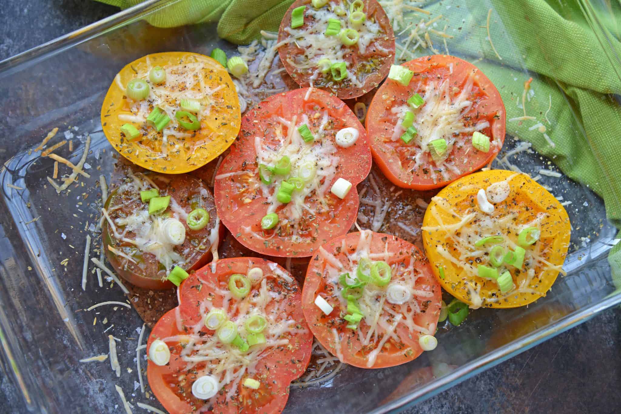 Parmesan Tomatoes are whole tomatoes, cut in half and baked with Parmesan cheese, Italian seasoning and garnished with lush scallions. An easy side dish recipe for any meal!  #tomatosidedishrecipes www.savoryexperiments.com 