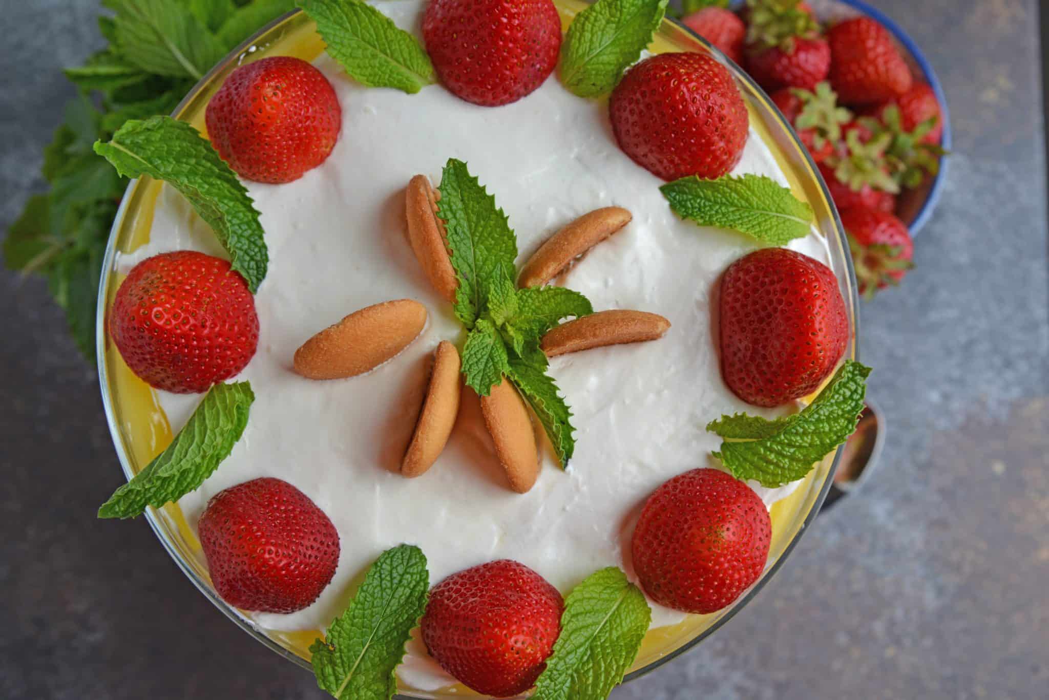 Strawberry Pudding Trifle dessert is just like classic banana pudding, but with strawberries. Layers of wafer, pudding, strawberry and cream cheese whipped cream make this easy dessert recipe a winner! #strawberrypuddingtrifle #trifledessert www.savoryexperiments.com