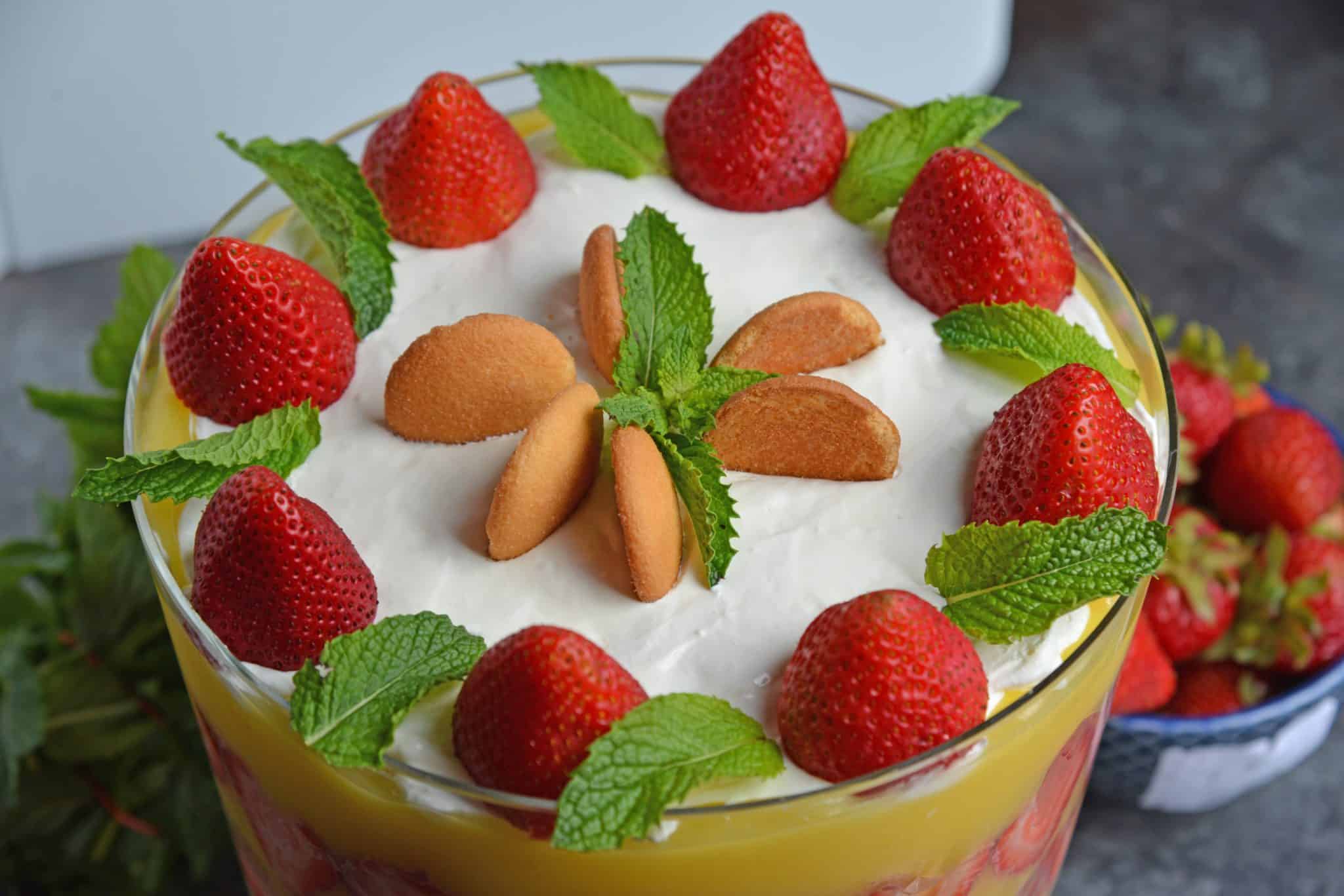 Strawberry Pudding Trifle dessert is just like classic banana pudding, but with strawberries. Layers of wafer, pudding, strawberry and cream cheese whipped cream make this easy dessert recipe a winner! #strawberrypuddingtrifle #trifledessert www.savoryexperiments.com