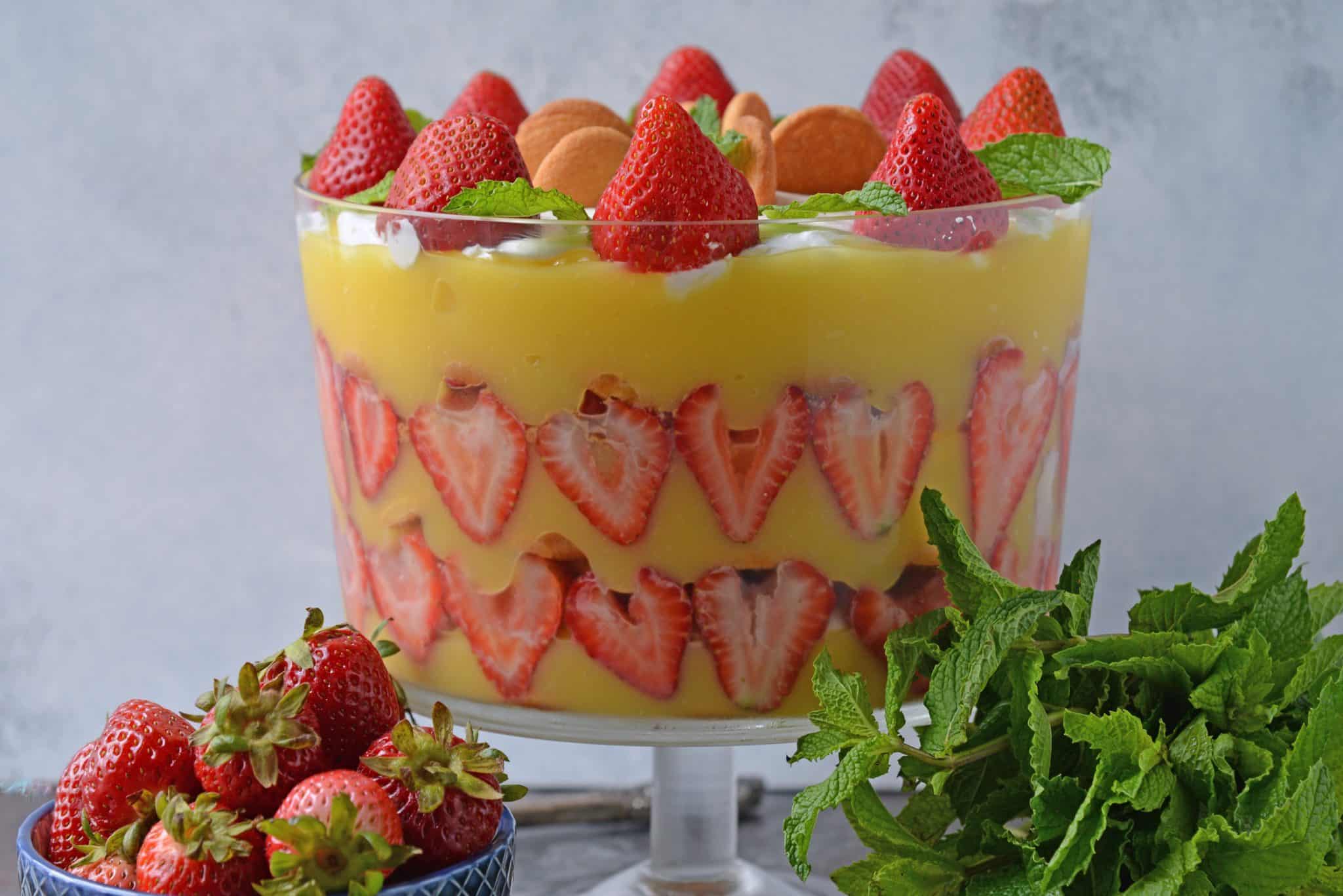 Strawberry Pudding Trifle dessert is just like classic banana pudding, but with strawberries. Layers of wafer, pudding, strawberry and cream cheese whipped cream make this easy dessert recipe a winner! #strawberrypuddingtrifle #trifledessert www.savoryexperiments.com