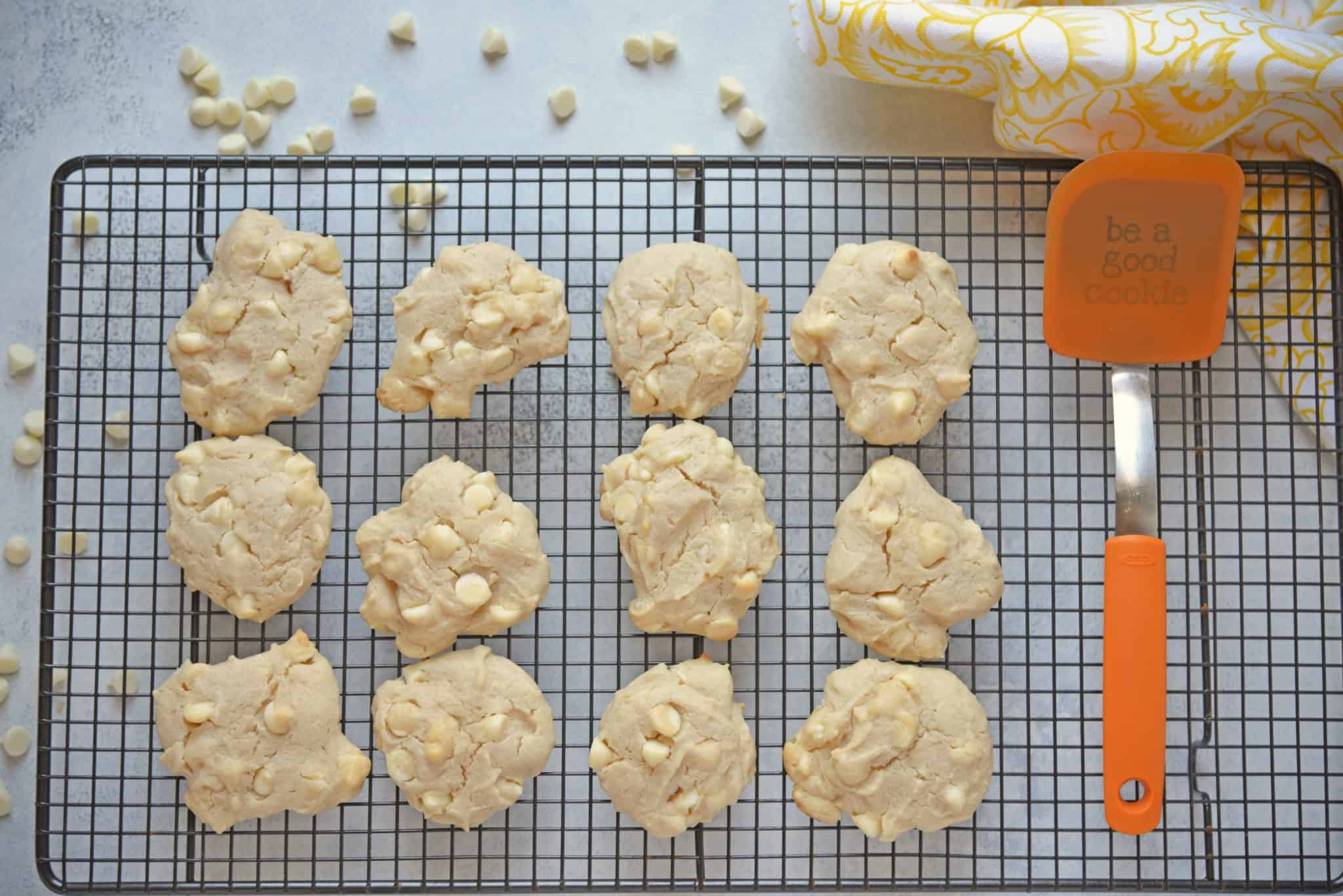 These Lemon White Chocolate Chip Cookies are a cross between a chocolate chip cookie & a lemon sugar cookie! A perfectly fluffy & mouth watering combination! #lemoncookierecipe #lemoncookies #whitechocolatechipcookies www.savoryexperiments.com