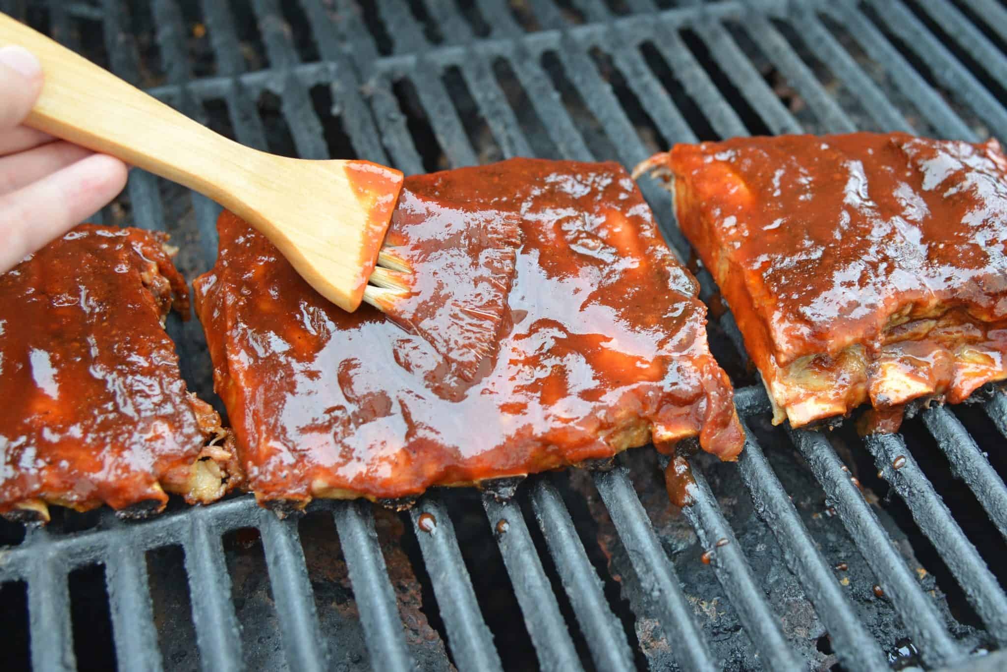 This is the Best BBQ Ribs Recipe you'll ever find! This pork ribs recipe falls right off the bone and is smothered in an award winning BBQ sauce! #howtomakeribsonthegrill #BBQribs www.savoryexperiments.com