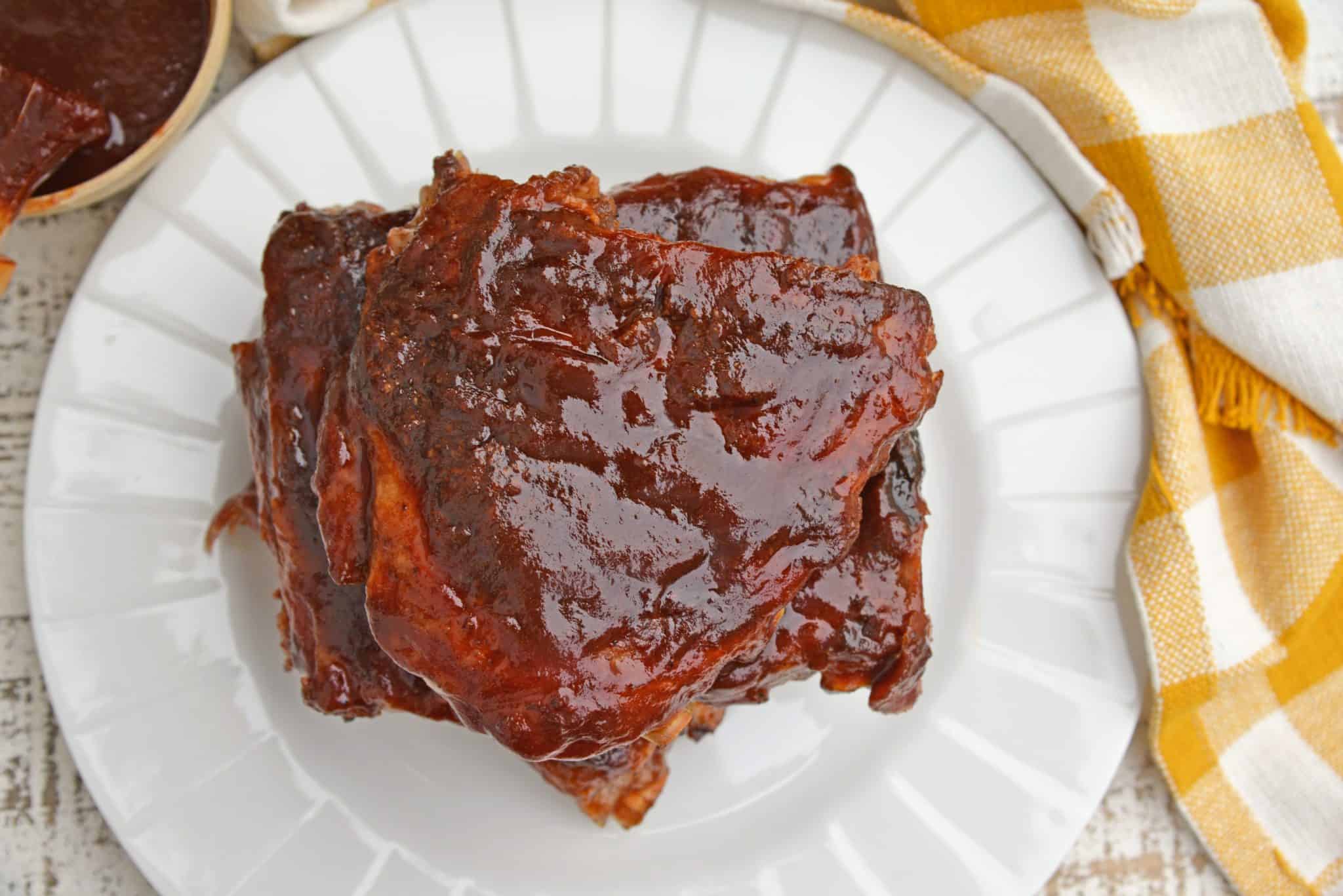 This is the Best BBQ Ribs Recipe you'll ever find! This pork ribs recipe falls right off the bone and is smothered in an award winning BBQ sauce! #howtomakeribsonthegrill #BBQribs www.savoryexperiments.com