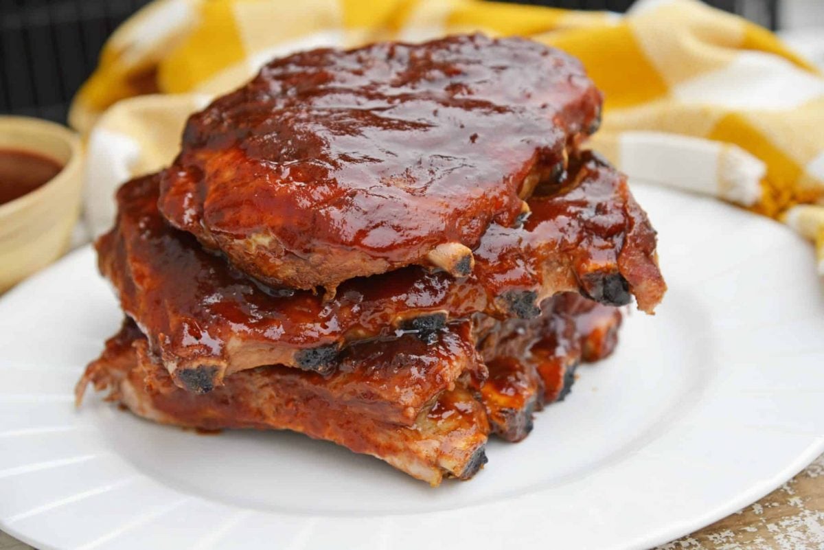 This is the Best BBQ Ribs Recipe you'll ever find! This pork ribs recipe falls right off the bone and is smothered in an award winning BBQ sauce! #howtomakeribsonthegrill #BBQribs www.savoryexperiments.com