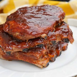 This is the Best BBQ Ribs Recipe you'll ever find! This pork ribs recipe falls right off the bone and is smothered in an award winning BBQ sauce! #howtomakeribsonthegrill #BBQribs www.savoryexperiments.com