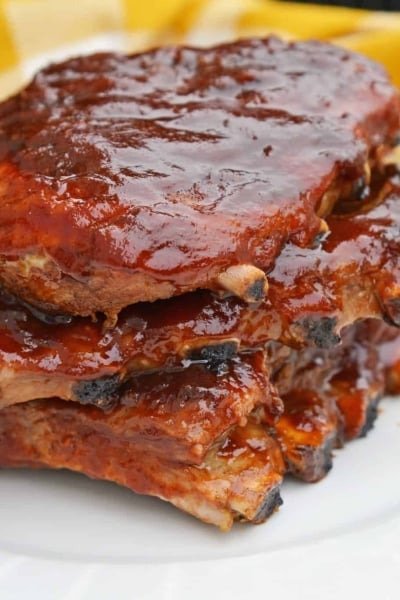 This is the Best BBQ Ribs Recipe you'll ever find! This pork ribs recipe falls right off the bone and is smothered in an award winning BBQ sauce! #howtomakeribsonthegrill #BBQribs www.savoryexperiments.com