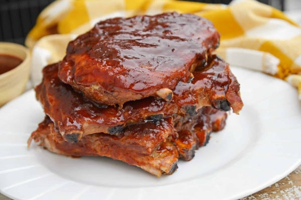 This is the Best BBQ Ribs Recipe you'll ever find! This pork ribs recipe falls right off the bone and is smothered in an award winning BBQ sauce! #howtomakeribsonthegrill #BBQribs www.savoryexperiments.com
