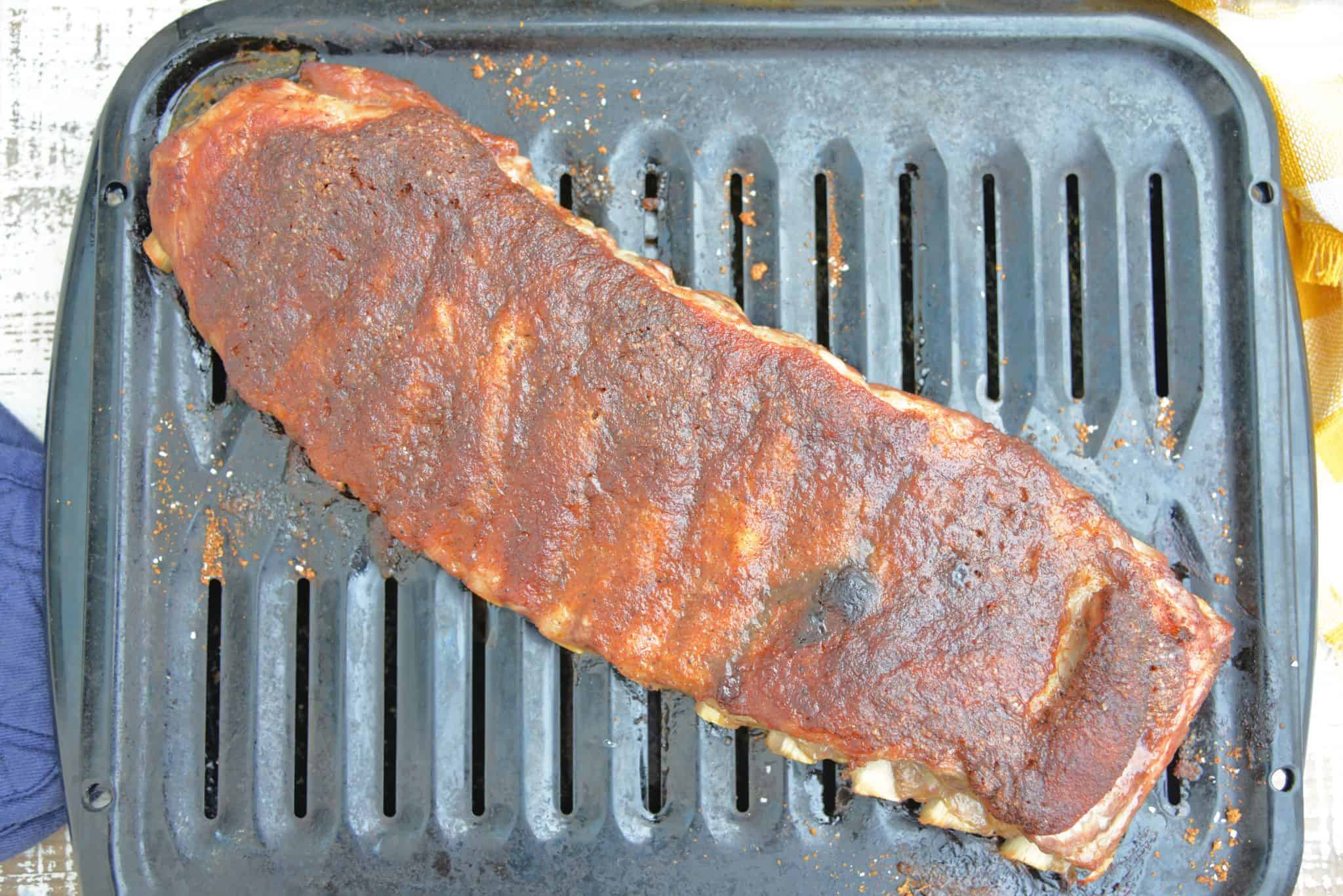 This is the Best BBQ Ribs Recipe you'll ever find! This pork ribs recipe falls right off the bone and is smothered in an award winning BBQ sauce! #howtomakeribsonthegrill #BBQribs www.savoryexperiments.com