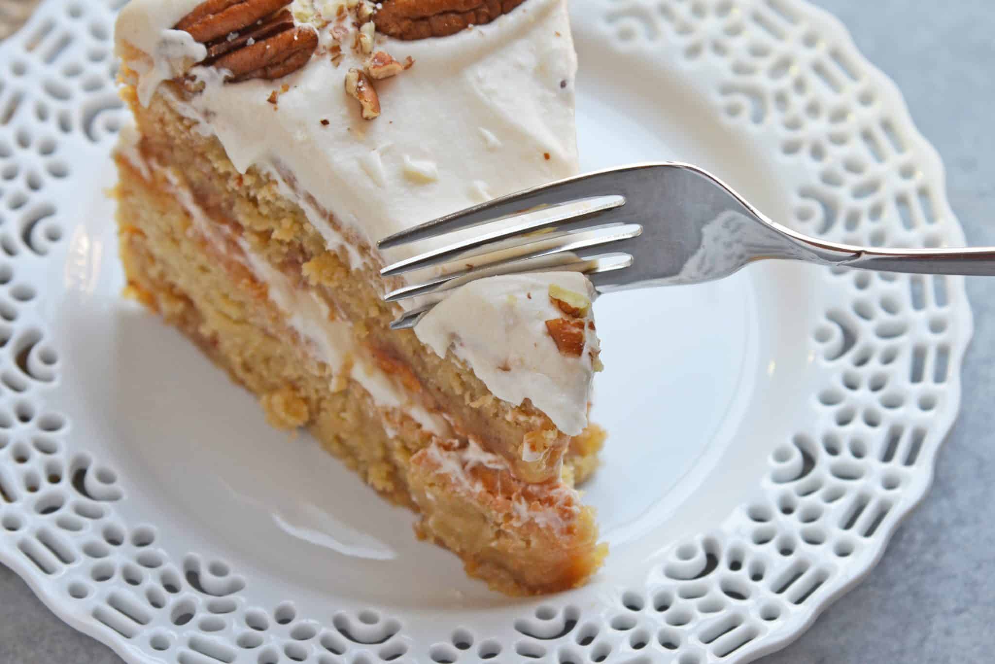 Brown Butter Caramel Cake is a two layer naked cake made with toffee bits and salted caramel frosting! The perfect summer cake or show stopping centerpiece. #caramelcake #brownbuttercake #nakedcakes www.savoryexperiments.com