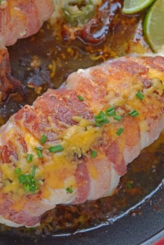 Jalapeno Bacon Wrapped Chicken is a cheese stuffed chicken breast recipe using three cheeses and fresh jalapenos. Avocado and lime cool off the hot flavors. #baconwrappedchicken #jalapenopopperchicken www.savoryexperiments.com