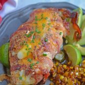 Jalapeno Bacon Wrapped Chicken is a cheese stuffed chicken breast recipe using three cheeses and fresh jalapenos. Avocado and lime cool off the hot flavors. #baconwrappedchicken #jalapenopopperchicken www.savoryexperiments.com