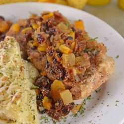 Fruit Smothered Pork Chops are pan fried pork chops with a zesty dried fruit sauce, taking 30 minutes from start to finish! #fruitsmotheredporkchops #panfriedporkchops www.savoryexperiments.com