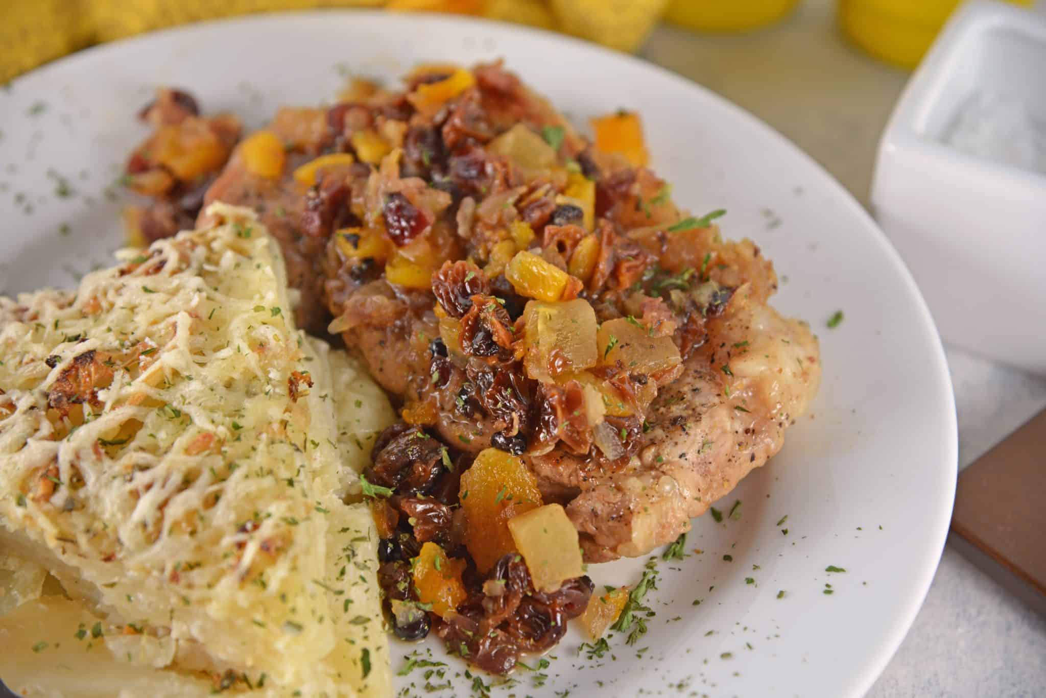 Fruit Smothered Pork Chops are pan fried pork chops with a zesty dried fruit sauce, taking 30 minutes from start to finish! #fruitsmotheredporkchops #panfriedporkchops www.savoryexperiments.com