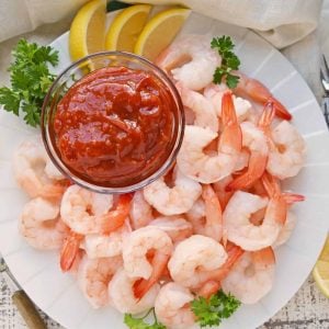 Shrimp Cocktail on a white plate with a small bowl of cocktail sauce