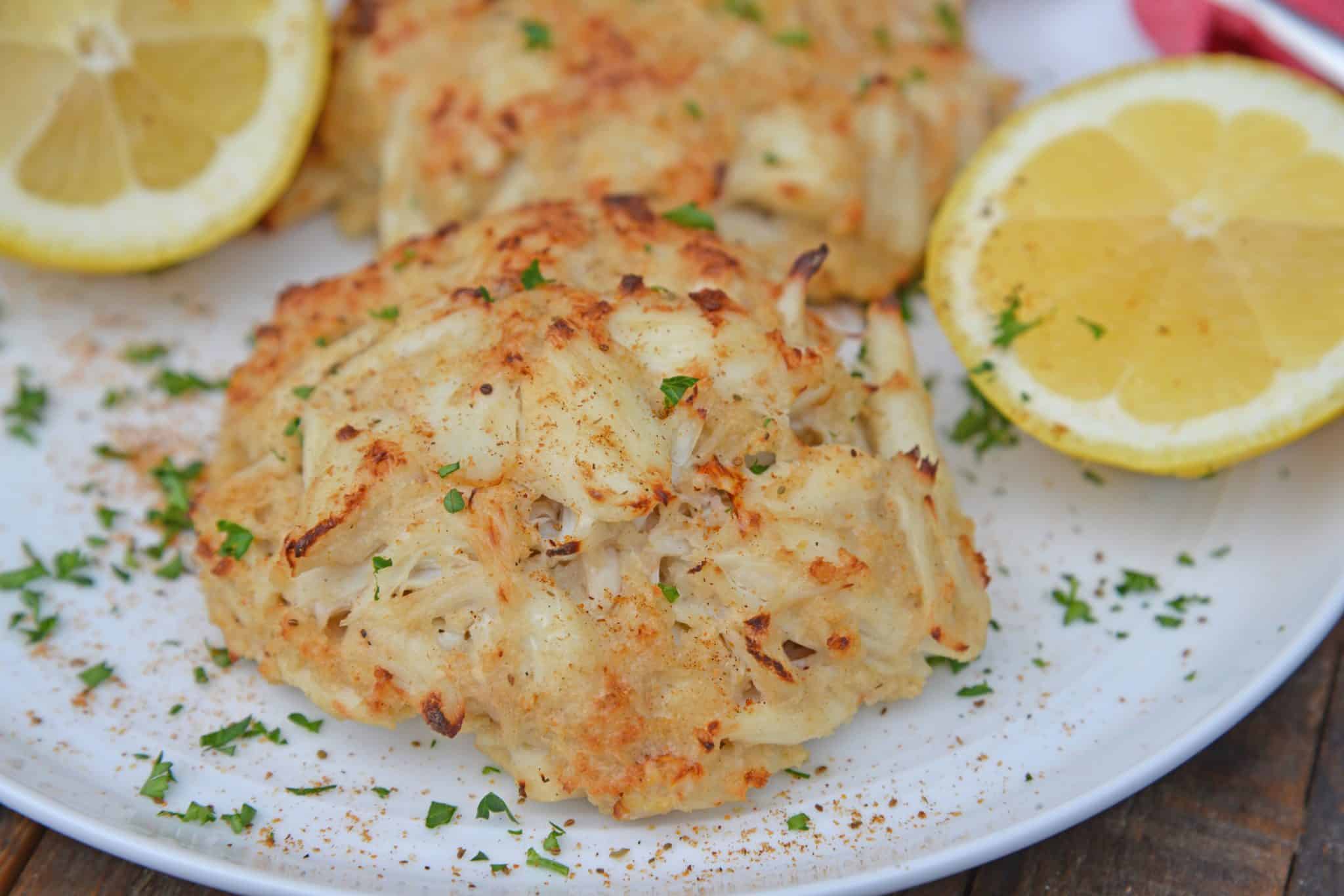 Close up of Maryland Crab Cakes on a white plate with lemons