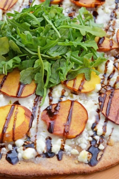 Peach Pizza is a delicious pizza variation that uses fresh peaches, melty mozzarella and gorgonzola cheeses and a sweet balsamic reduction sauce. The best homemade pizza recipe! #homemadepizzarecipe www.savoryexperiments.com