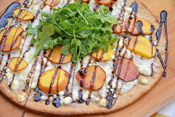 Peach Pizza is a delicious pizza variation that uses fresh peaches, melty mozzarella and gorgonzola cheeses and a sweet balsamic reduction sauce. The best homemade pizza recipe! #homemadepizzarecipe www.savoryexperiments.com