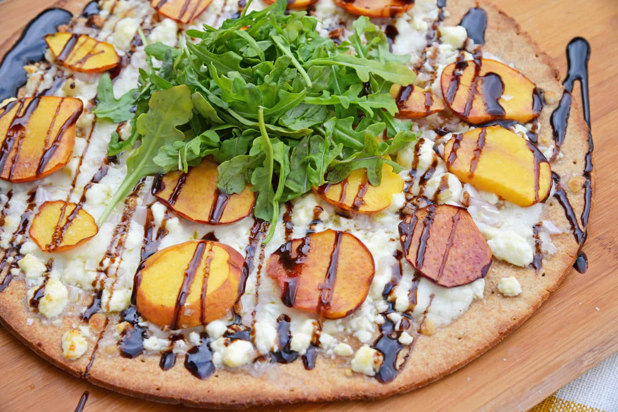 Peach Pizza is a delicious pizza variation that uses fresh peaches, melty mozzarella and gorgonzola cheeses and a sweet balsamic reduction sauce. The best homemade pizza recipe! #homemadepizzarecipe www.savoryexperiments.com