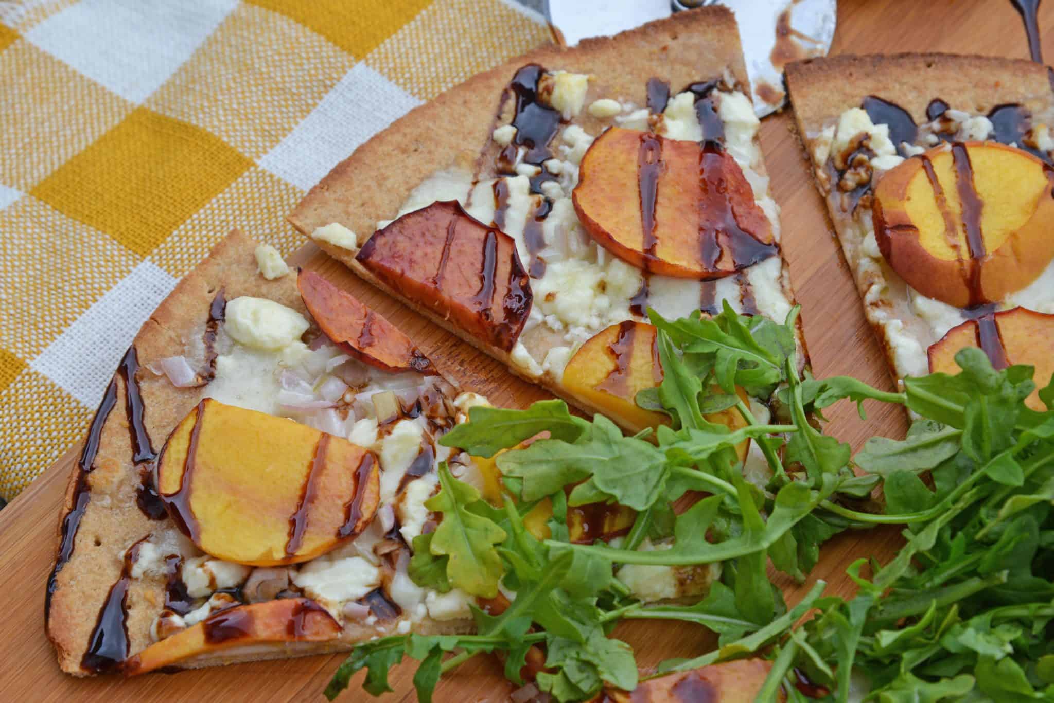 Peach Pizza is a delicious pizza variation that uses fresh peaches, melty mozzarella and gorgonzola cheeses and a sweet balsamic reduction sauce. The best homemade pizza recipe! #homemadepizzarecipe www.savoryexperiments.com