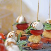 Caprese Skewers are the perfect party appetizer made with fresh mozzarella, basil, tomatoes, garlicky croutons, and zesty pepperoni, all drizzled with a tangy balsamic reduction sauce! #capresesalad #capreseappetizer www.savoryexperiments.com