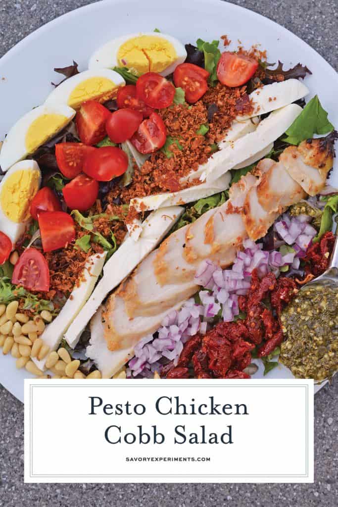 Pesto Chicken Cobb Salad is a delicious salad recipe using traditional Cobb ingredients with chicken and a pesto dressing. The perfect starter or entree! #Cobbsaladrecipe #pestochickensalad www.savoryexperiments.com