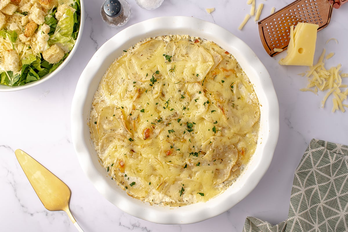 overhead of herbed potato galette in a round serving dish