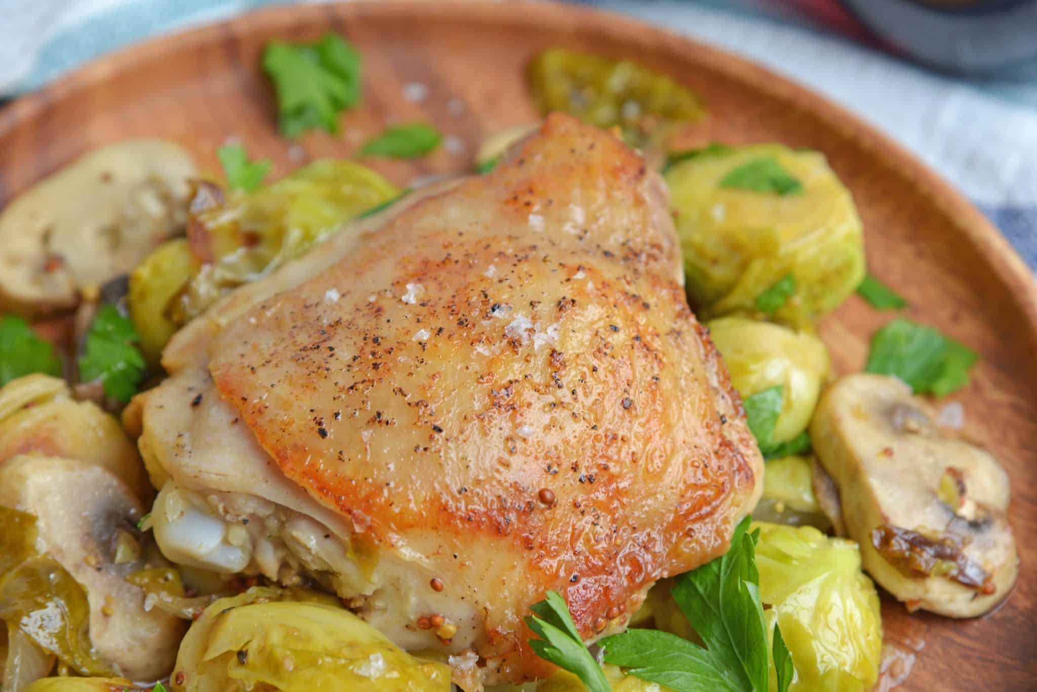 Chicken Dijon is an easy dinner recipe using chicken thighs, mushrooms, brussels sprouts, sweet onions, apple juice and of course, Dijon mustard! #chickendijon #mustardchicken #easychickenrecipe www.savoryexperiments.com 