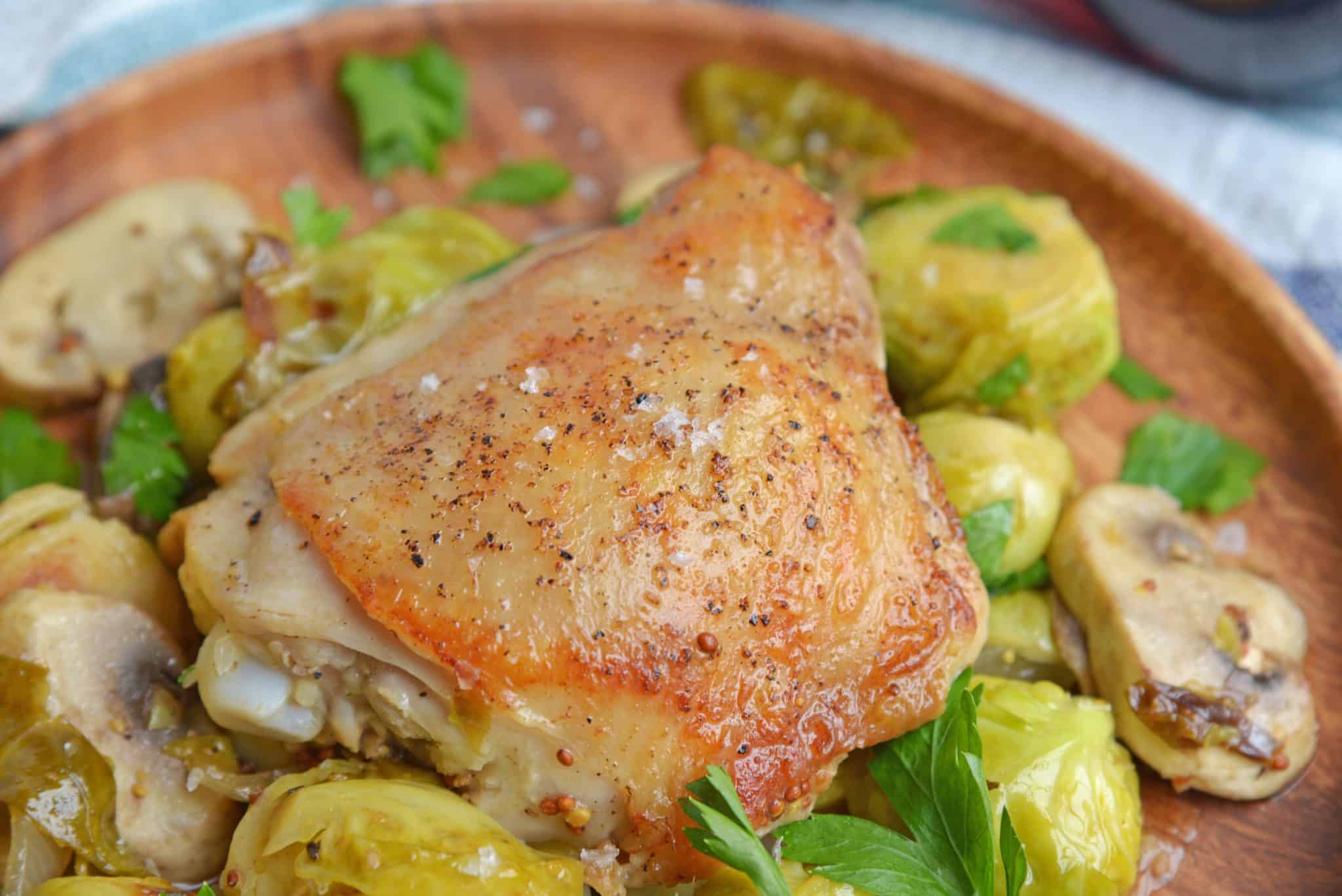 Chicken Dijon is an easy dinner recipe using chicken thighs, mushrooms, brussels sprouts, sweet onions, apple juice and of course, Dijon mustard! #chickendijon #mustardchicken #easychickenrecipe www.savoryexperiments.com