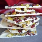 Pistachio Cranberry Bark is a delicious combination of pistachios, cranberries, and white chocolate! Perfect for the holiday season with its festive colors! #christmasbarkrecipe #pistachiocranberrybark www.savoryexperiments.com