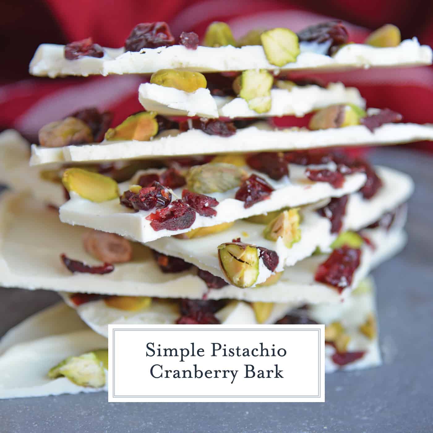 Pistachio Cranberry Bark is a delicious combination of pistachios, cranberries, and white chocolate! Perfect for the holiday season with its festive colors! #christmasbarkrecipe #pistachiocranberrybark www.savoryexperiments.com