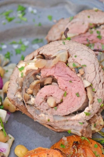 Mushroom Cheese Stuffed Flank Steak is a delicious and succulent main dish with cheese, mushrooms and garlic. The best flank steak pinwheel recipe! #stuffedflanksteak #flanksteakrecipe www.savoryexperiments.com