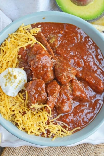 Red Beef Chili uses chunks of steak and simmers them to tender perfection in a chili tomato sauce. Serve over rice, noodles or as a stew. #bestchilirecipe #bobbyflay #redbeefchili www.savoryexperiments.com