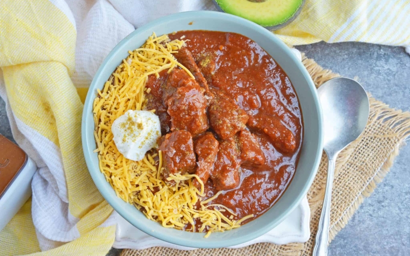 Red Beef Chili uses chunks of steak and simmers them to tender perfection in a chili tomato sauce. Serve over rice, noodles or as a stew. #bestchilirecipe #bobbyflay #redbeefchili www.savoryexperiments.com