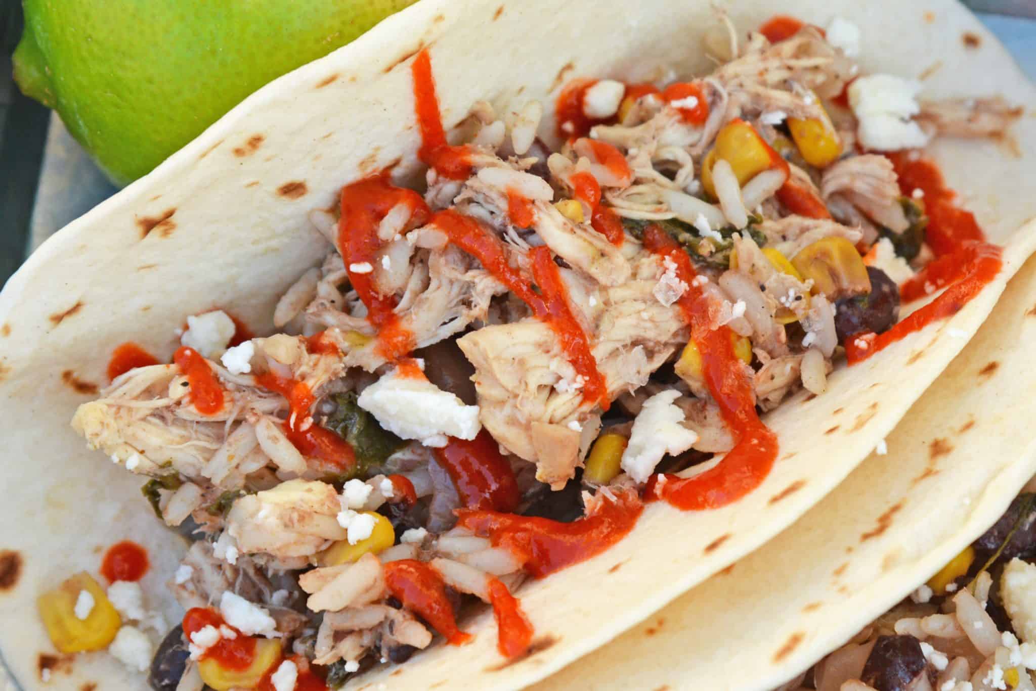 Slow Cooker Chicken Tacos only take 10 minutes to make in the crock pot! Just set it and forget it for a delicious dinner! #shreddedchickentacos #chickenstreettacos #softtacos www.savoryexperiments.com