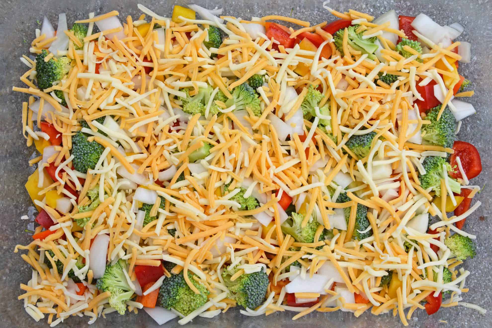 Cheesy Vegetable Breakfast Casserole uses fluffy eggs with broccoli, bell pepper, onion and cheese to make a delightful breakfast that is perfect for feeding a crowd! #vegetablecasserole #breakfastcasserole www.savoryexperiments.com 