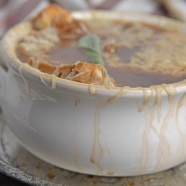 Apple French Onion Soup combines a robust French Onion Soup Recipe using sweet apples for flavor and texture. Top with crunchy garlic croutons and gooey cheese. #frenchonionsoup #fallsoup www.savoryexperiments.com