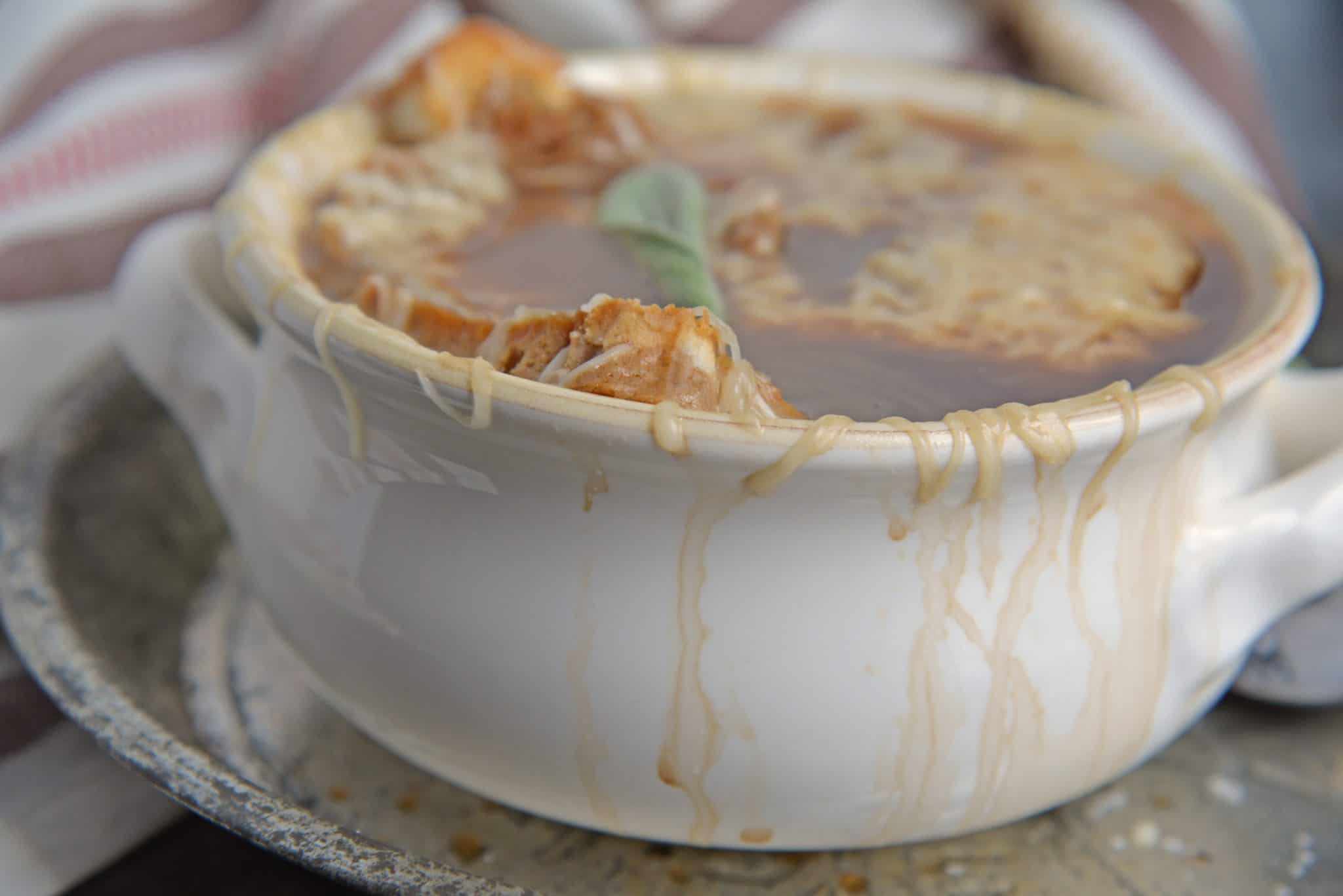 Apple French Onion Soup combines a robust French Onion Soup Recipe using sweet apples for flavor and texture. Top with crunchy garlic croutons and gooey cheese. #frenchonionsoup #fallsoup www.savoryexperiments.com